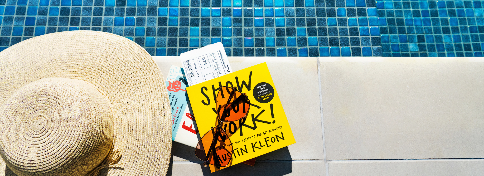 Hat and books by the poolside